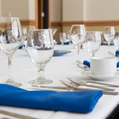 fully set table of cutlery and glasses in meeting room 415